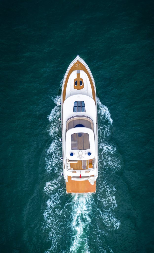 Aerial view of a motor cruiser under way over deep green water