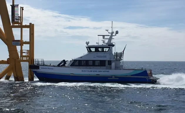 Crew transfer vessel alongside an offshore wind turbine foundation, the type of commercial workboat monitored by BRNKL